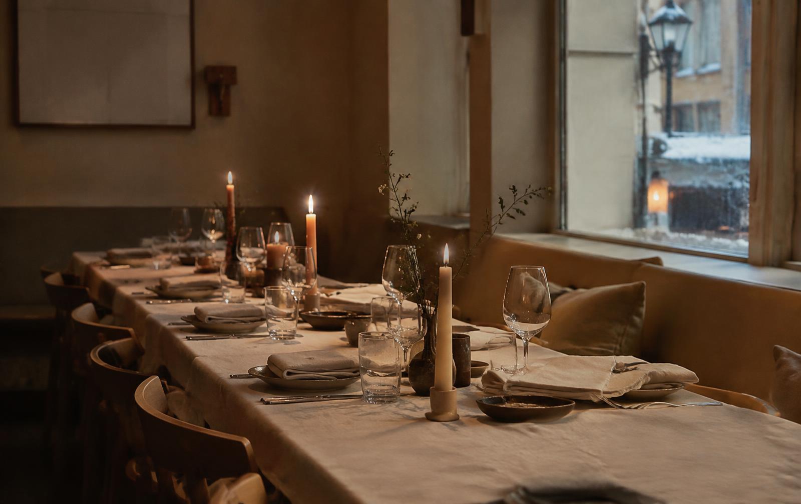 A long lunch table set with candles and glasses (placeholder photo)